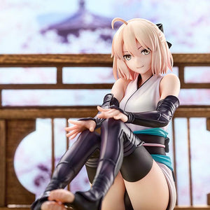 Close-up portrait of Okita Souji's Final Ascension version figure with a soft-focus cherry blossom background.