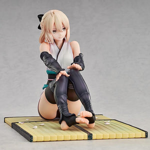 Angled view of the Okita Souji scale figure sitting on a tatami mat base with scattered cherry blossom petals.