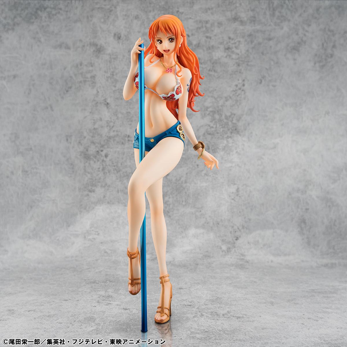 The limited edition Nami figure displayed in an atmospheric beach-themed diorama with stone pillars and a dark ocean background.