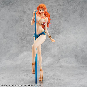 The limited edition Nami figure displayed in an atmospheric beach-themed diorama with stone pillars and a dark ocean background.