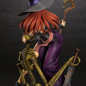 Rear view of the Sorceress figure with her hat on, showing the flowing red hair, purple skirt, and the skeleton holding a rusty sword.