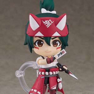 Full standing view of the Kiriko Nendoroid figure wearing her red and white shrine maiden outfit, mounted on a clear plastic display stand against a grey backdrop.
