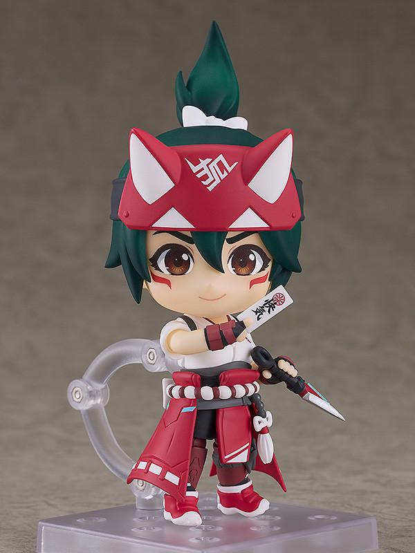 Full standing view of the Kiriko Nendoroid figure wearing her red and white shrine maiden outfit, mounted on a clear plastic display stand against a grey backdrop.