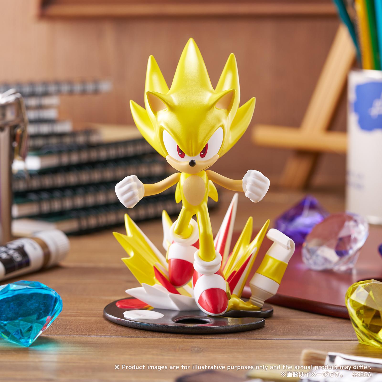 Promotional lifestyle display shot of the PalVerse Pale Super Sonic figure on a wooden desk surrounded by bright gems and art supplies.