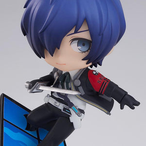 Close-up detail of the Persona 3 hero Makoto Yuki Nendoroid figure crouching on a blue tile panel while wielding a sword.