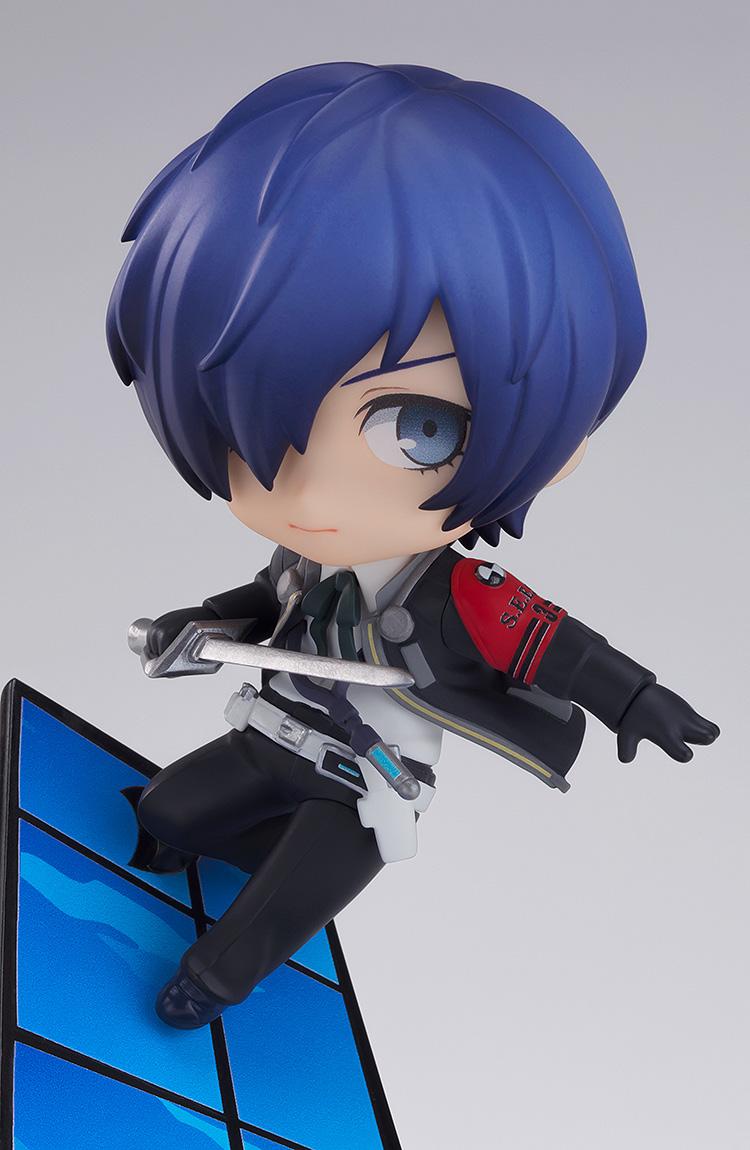 Close-up detail of the Persona 3 hero Makoto Yuki Nendoroid figure crouching on a blue tile panel while wielding a sword.