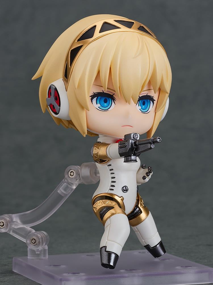 Nendoroid Aigis 2.0 figure in a dynamic pose holding the included machine gun accessory.