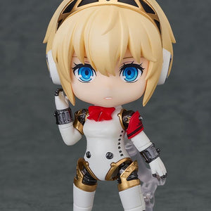 Nendoroid Aigis 2.0 figure standing with a neutral expression, highlighting her golden headset and combat suit design.