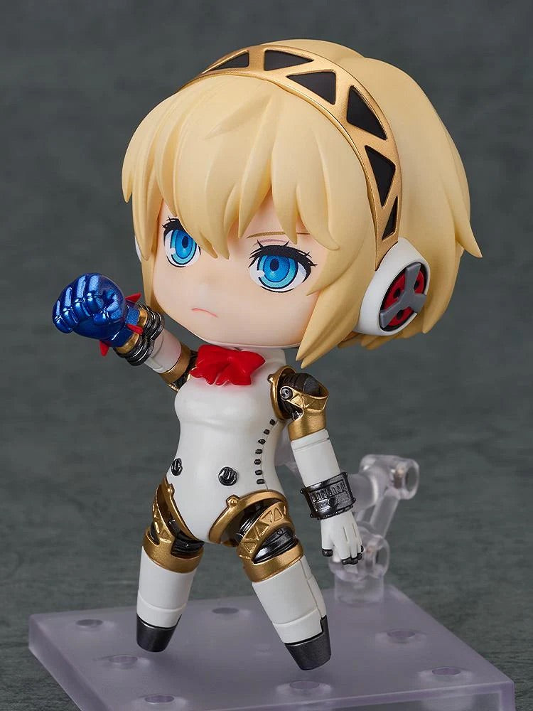 Nendoroid Aigis 2.0 figure posed performing a "Rocket Punch" action with the small blue effect part attached to her forearm.