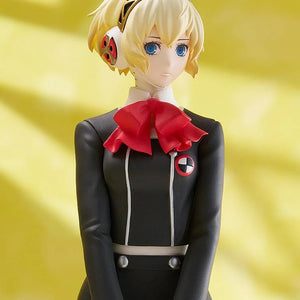 Detailed close-up on the face and head of the Aigis figure, showing her blonde hair, blue eyes, and her unique headphones/head gear.