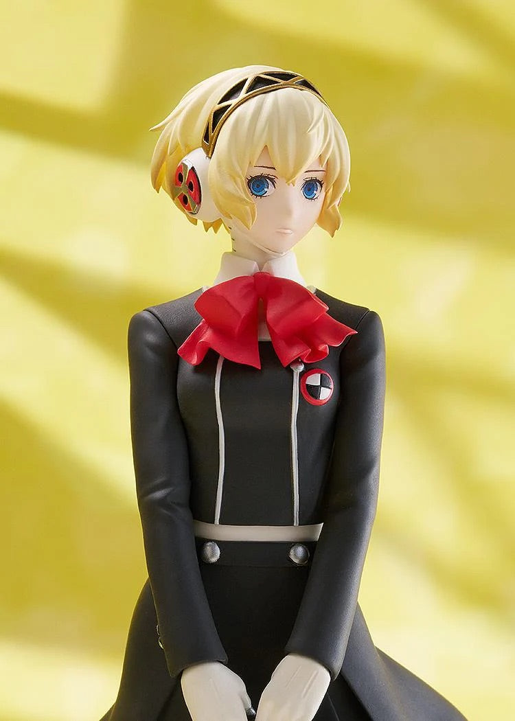 Detailed close-up on the face and head of the Aigis figure, showing her blonde hair, blue eyes, and her unique headphones/head gear.