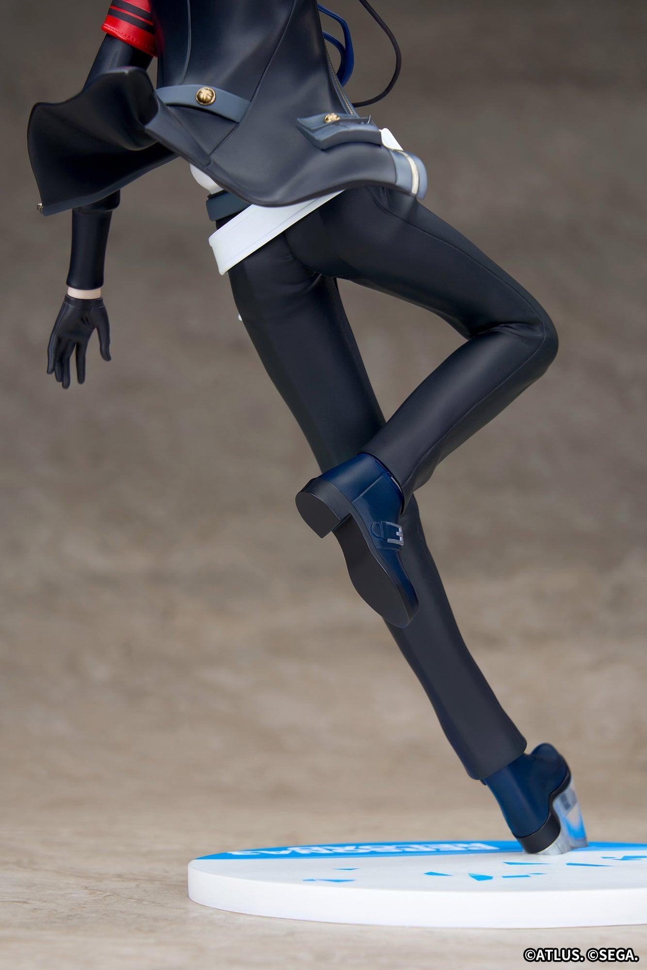 Detailed view of the Persona 3 Reload Protagonist figure's tailored pants, dark blue boots, and transparent base support peg.