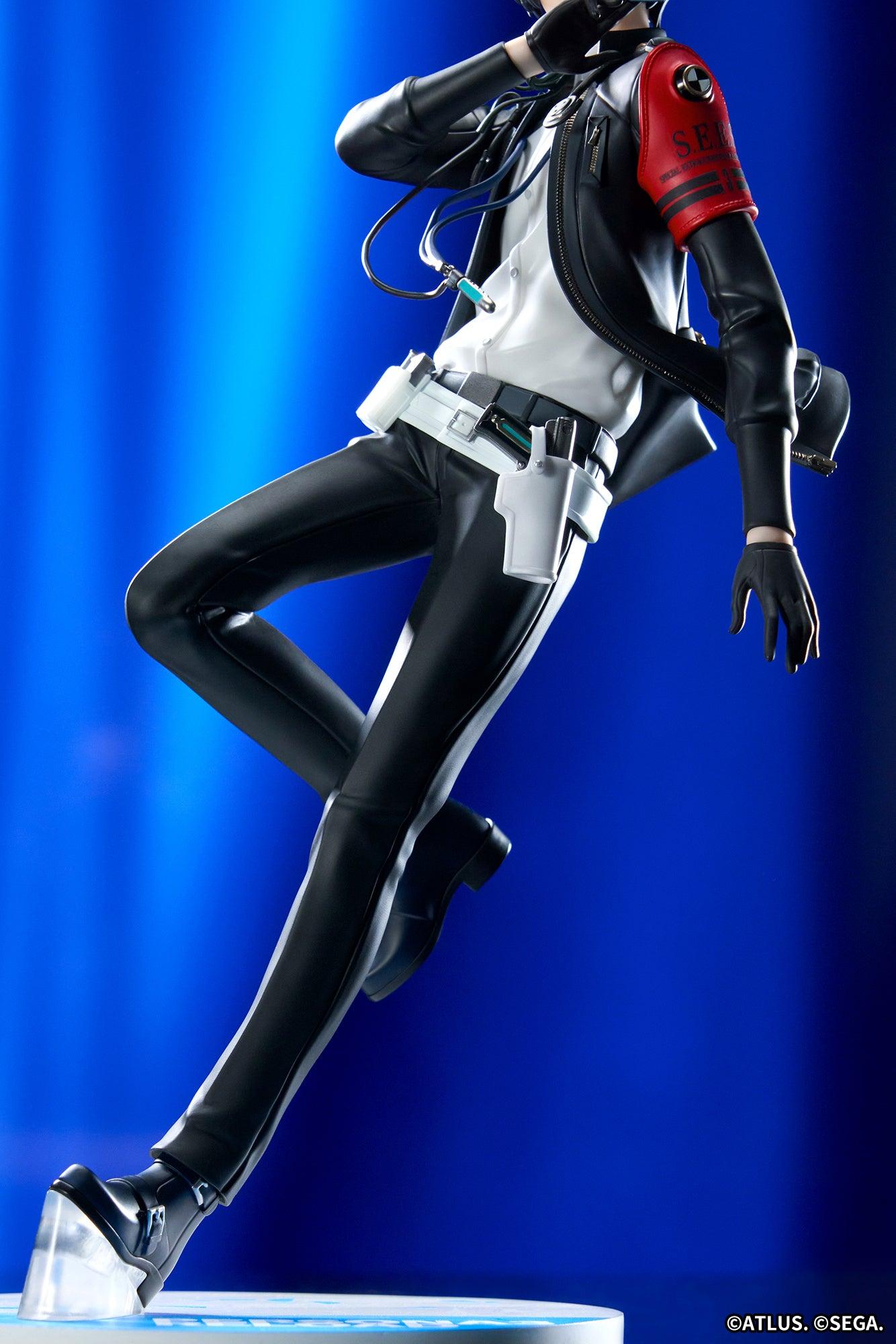Low-angle photo of the Persona 3 Reload Protagonist figure focusing on the sculpted legs, holster, and logo base in blue light.