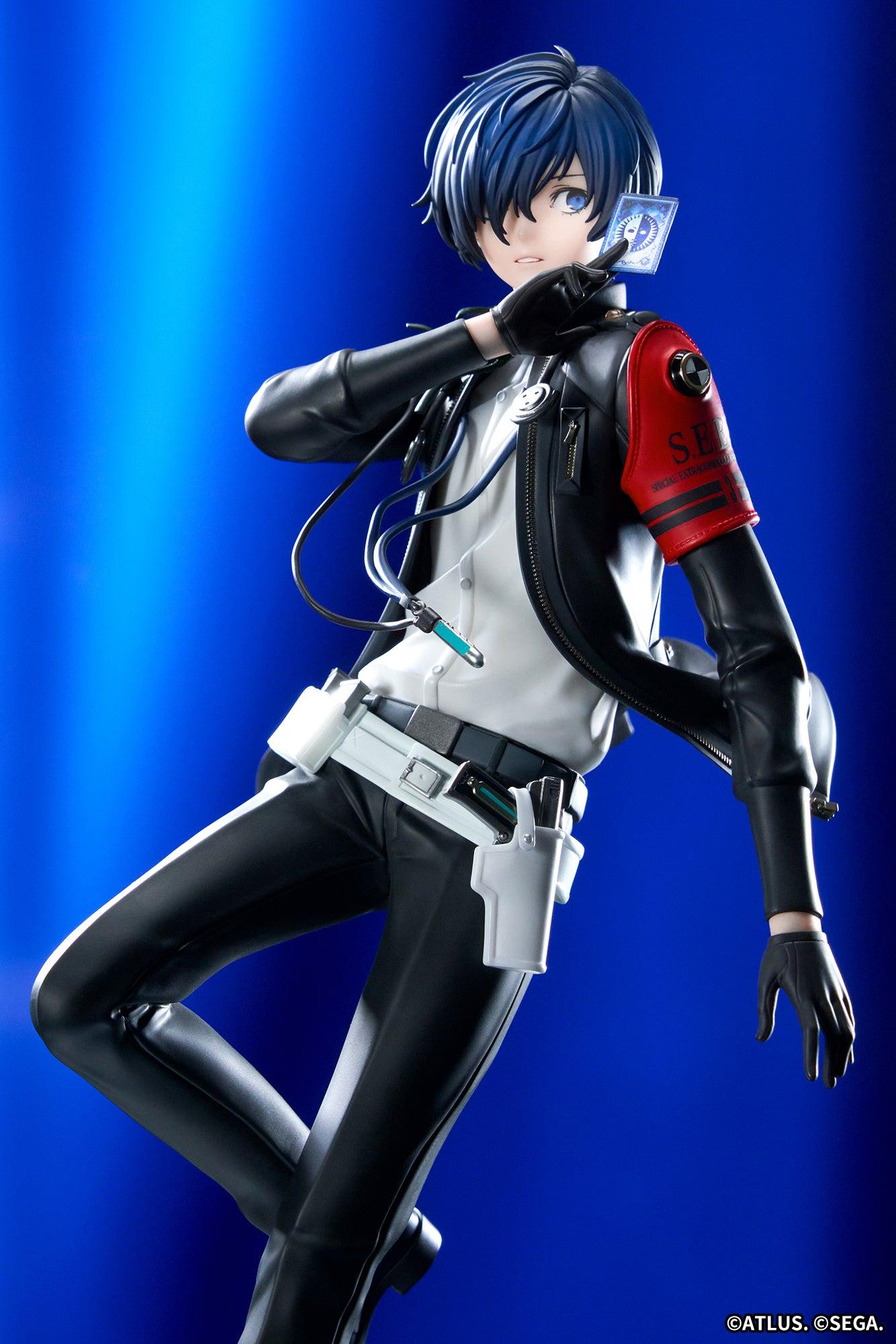 Three-quarter view of the Persona 3 Reload Protagonist figure holding the tarot card under radiant blue backdrop lighting.