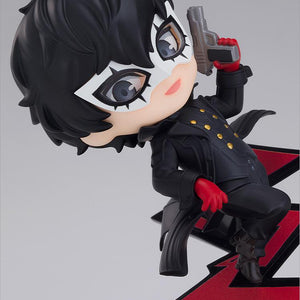 Close-up view of the Persona 5 Joker Nendoroid figure aiming a gun and wearing his mask over a red jagged path background.