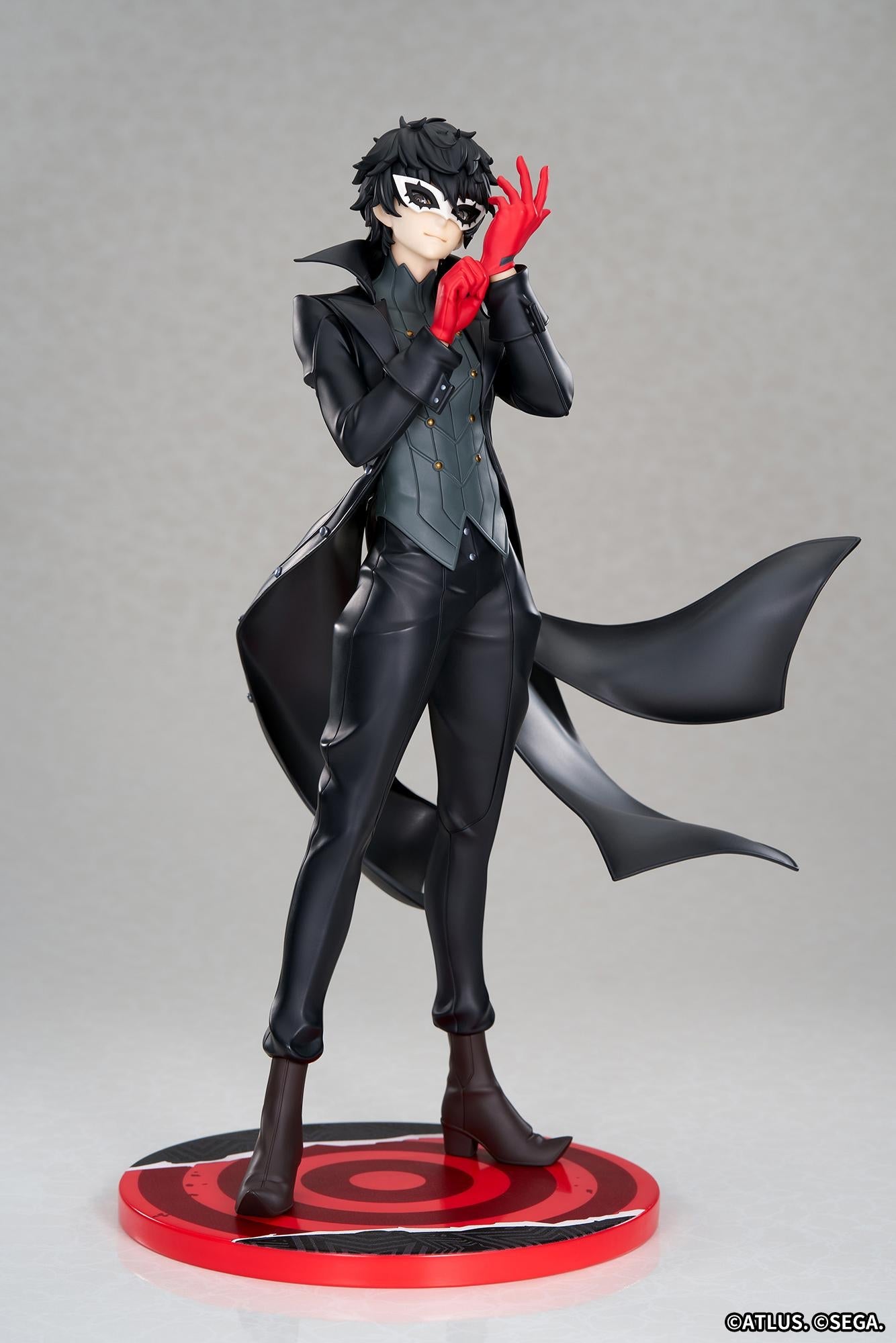 Full-body front view of the Persona 5 Royal Joker 1/8 scale figure by Apex in his black Phantom Thief trench coat adjusting his red gloves against a studio gray background.