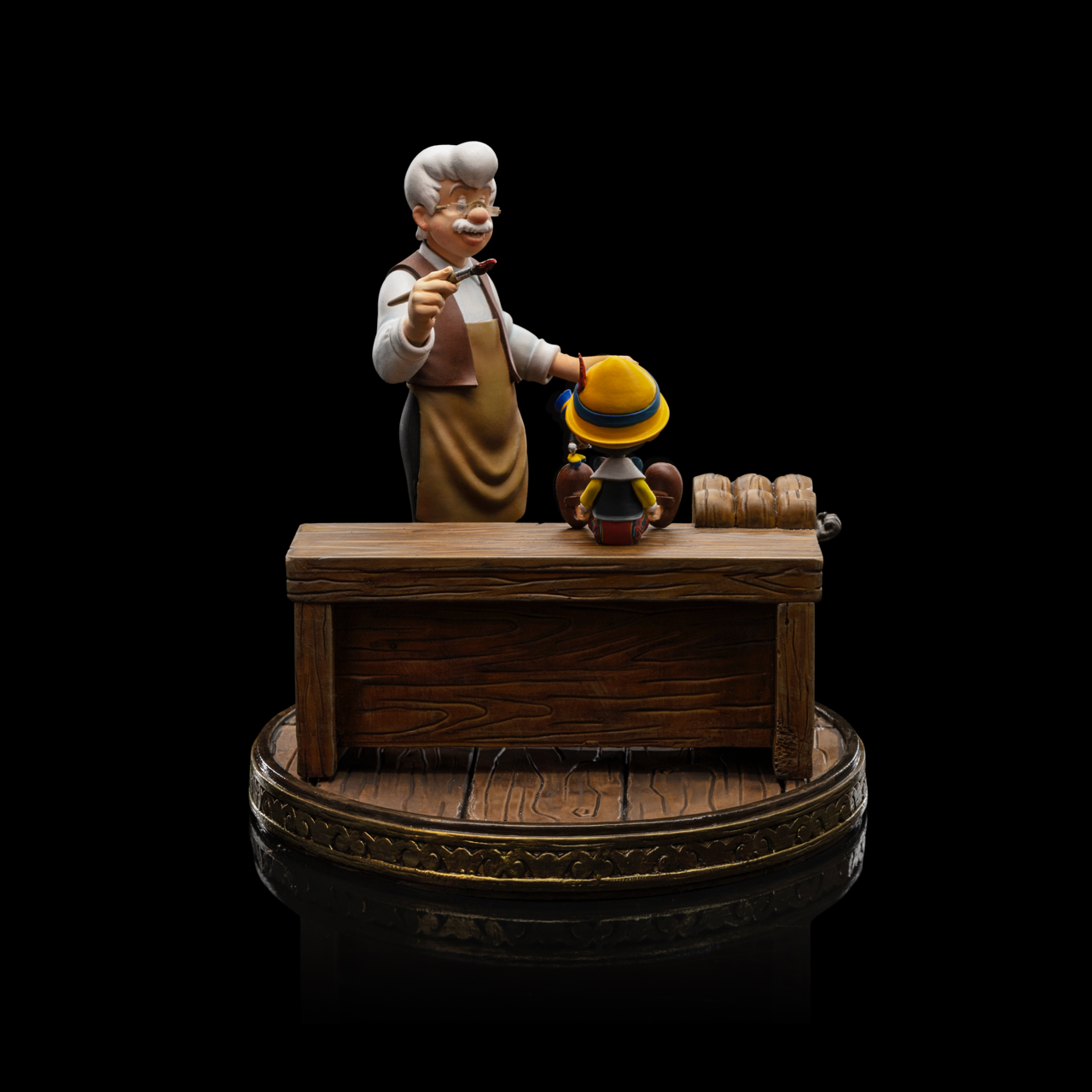 A rear view of the Pinocchio statue by Iron Studios, showcasing the workbench and the back of Pinocchio and Geppetto.