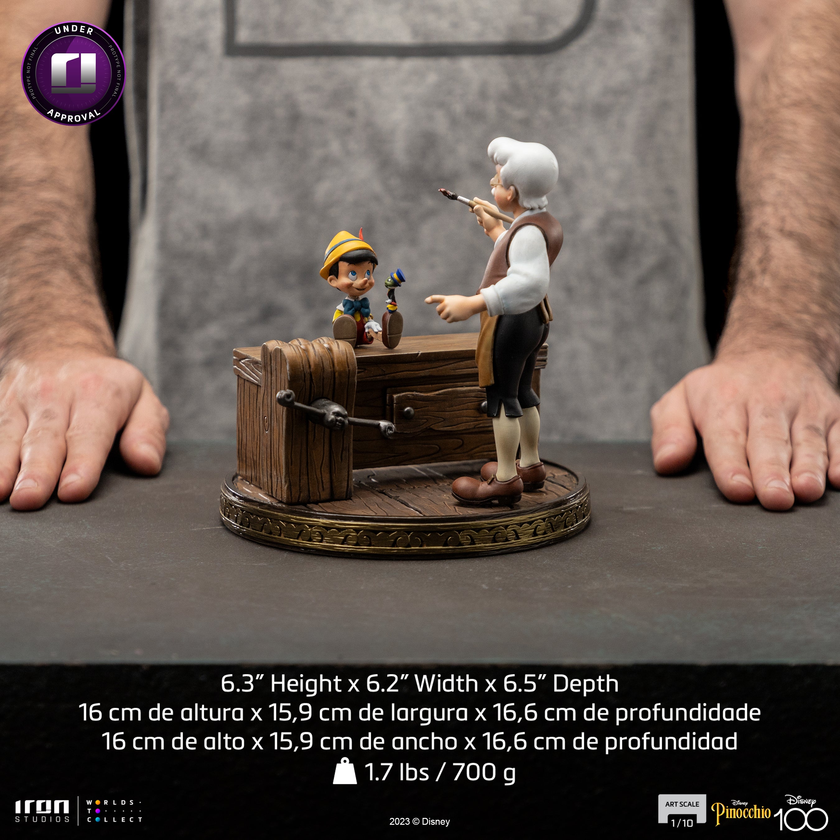 A product image of the Iron Studios Pinocchio statue next to a person's hands for scale, with dimensions listed as 6.3 inches in height.