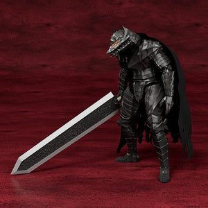 Full body studio product shot of PLAMATEA Guts Berserker Armor Ver. model kit standing with the Dragon Slayer sword against a dark red textured background.