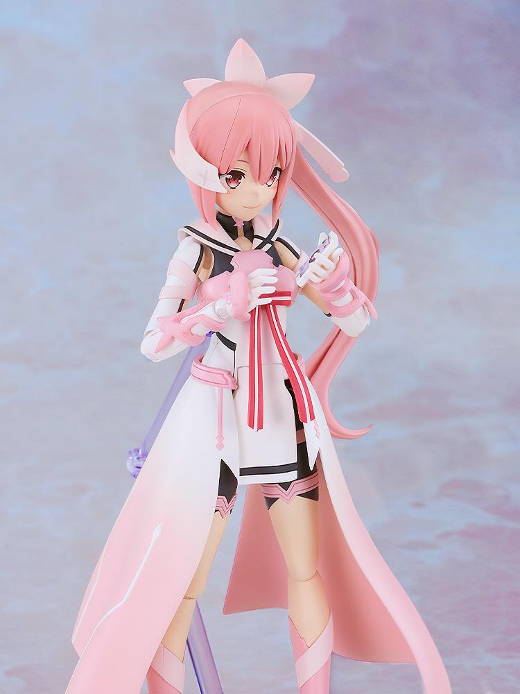 Close-up shot of the Yuki Yuna model kit looking down and holding her iconic pink smartphone accessory with a cheerful smiling expression.