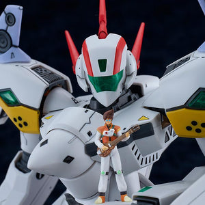 Close-up focus shot of the VF-19P Excalibur model kit's chest and head unit, holding the miniature 1/72 scale Basara Nekki figure with his guitar standing on its open robotic palm.