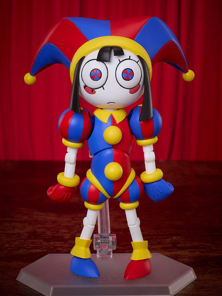 Front view of the fully assembled Pomni figma figure showing her standard neutral face plate with blue and red pinwheel eyes against a red curtain background.