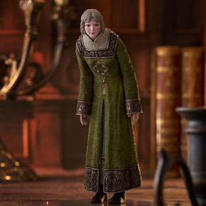 Rya figure from Elden Ring displayed in a library setting with books and a candle holder.