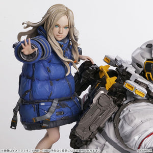 Macro close-up portrait of the Diana figure component, detailing her realistic blonde hair sculpt, green eyes, blue winter jacket, and extended right hand.