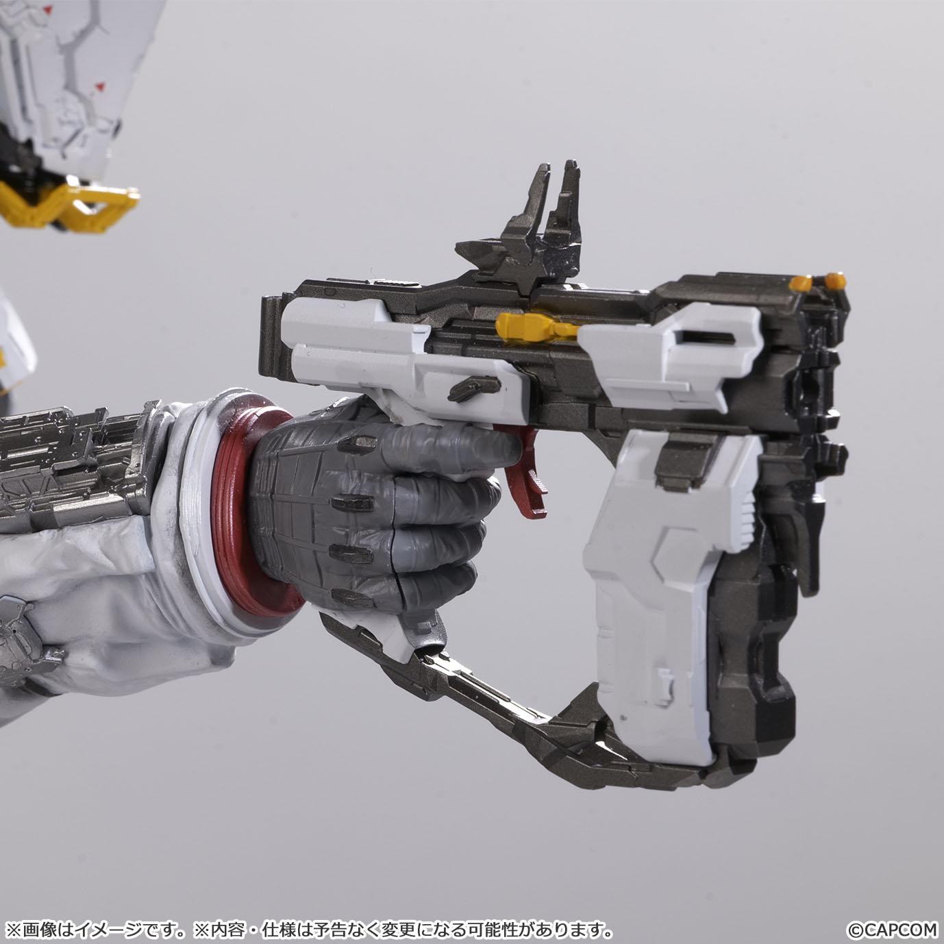 Macro view of the armored gray glove holding the white and gray sci-fi pistol weapon from the Capcom Pragmata figure line, highlighting the mechanical trigger and sight rails.