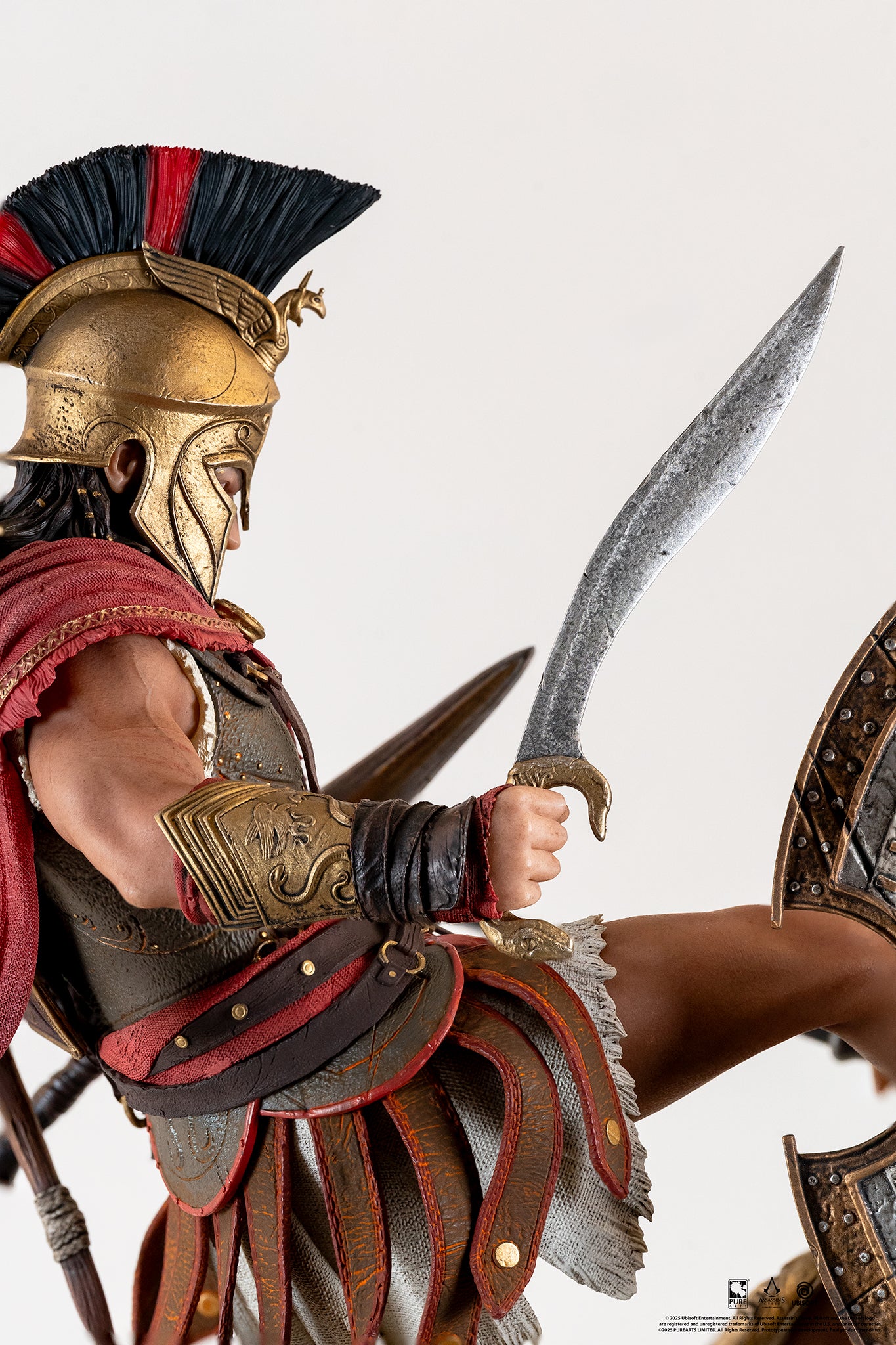 Close-up of Alexios wielding his curved Kopis sword, showing the detail of his red-plumed helmet and golden armor.