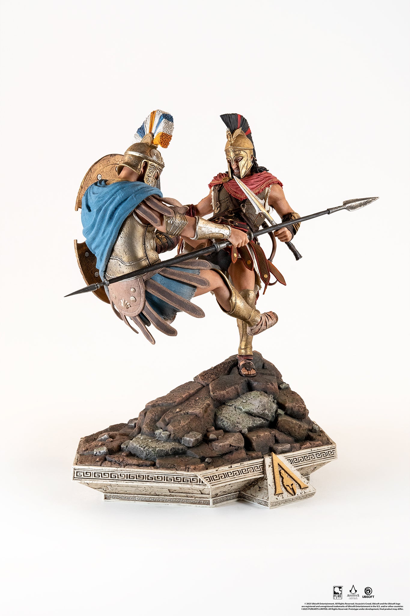 Side profile of the Alexios Spartan Kick statue, showcasing the two figures locked in combat above the rocky base.