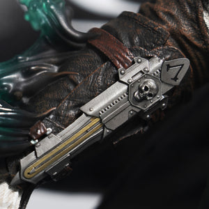 A detailed close-up of Edward Kenway’s forearm on the statue, showcasing his iconic hidden blade gauntlet with a skull and number seven emblem.
