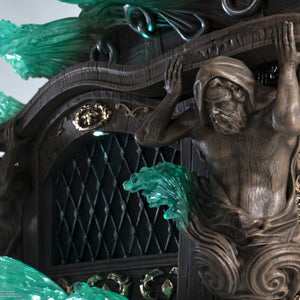 A detailed close-up of the Jackdaw ship base from the Edward Kenway statue, highlighting the sculpted wood grain and the mythological figures on the stern.

