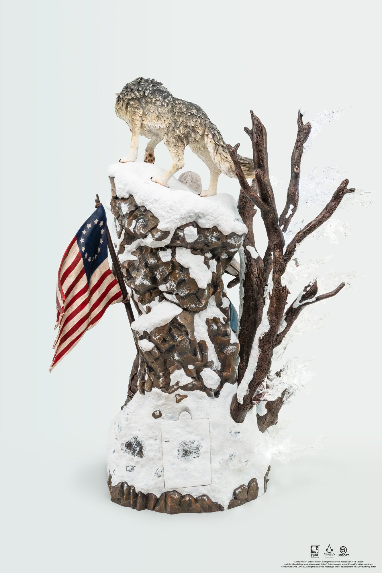 A rear view of the Animus Connor statue, focusing on the wolf and the detailed snowy rock bluff of the base, with Connor partially visible.