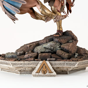 Close-up of the diorama base, highlighting the rugged rocky terrain and the decorative Greek architecture featuring the Assassin's Creed Odyssey logo.