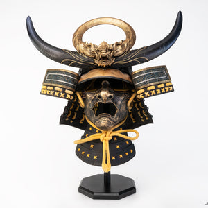 Front view of PureArts Assassin’s Creed Yasuke Samurai Helmet 1/1 Scale Replica with golden dragon crest and black horns.