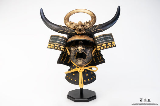 Front view of PureArts Assassin’s Creed Yasuke Samurai Helmet 1/1 Scale Replica with golden dragon crest and black horns.