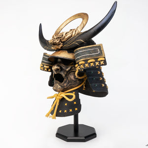 Left side angle of PureArts Assassin’s Creed Yasuke Samurai Helmet life-size replica showcasing detailed mask, horns, and golden accents.