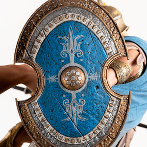 Close-up of the Athenian Commander's shield, showing its large size and the intricate blue, silver, and gold painted design.
