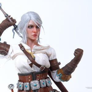 Close-up of the Ciri figure posed with her arm raised above her head, as if drawing her metal sword.