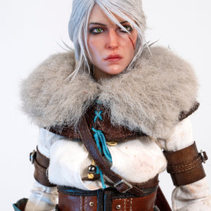 Close-up of the Ciri figure's face, wearing the large faux fur mantle and featuring her signature scar and piercing eyes.