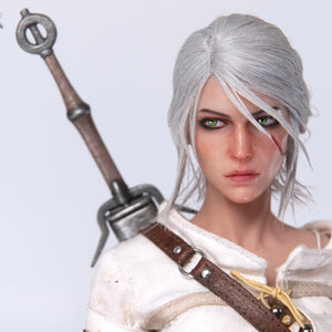 A close-up of the Ciri figure's face, highlighting the rooted white hair, scarred cheek, and intense green eyes.