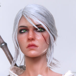 An intense close-up of Ciri's face, clearly showing the scar across her left cheek and the movable green eyes.