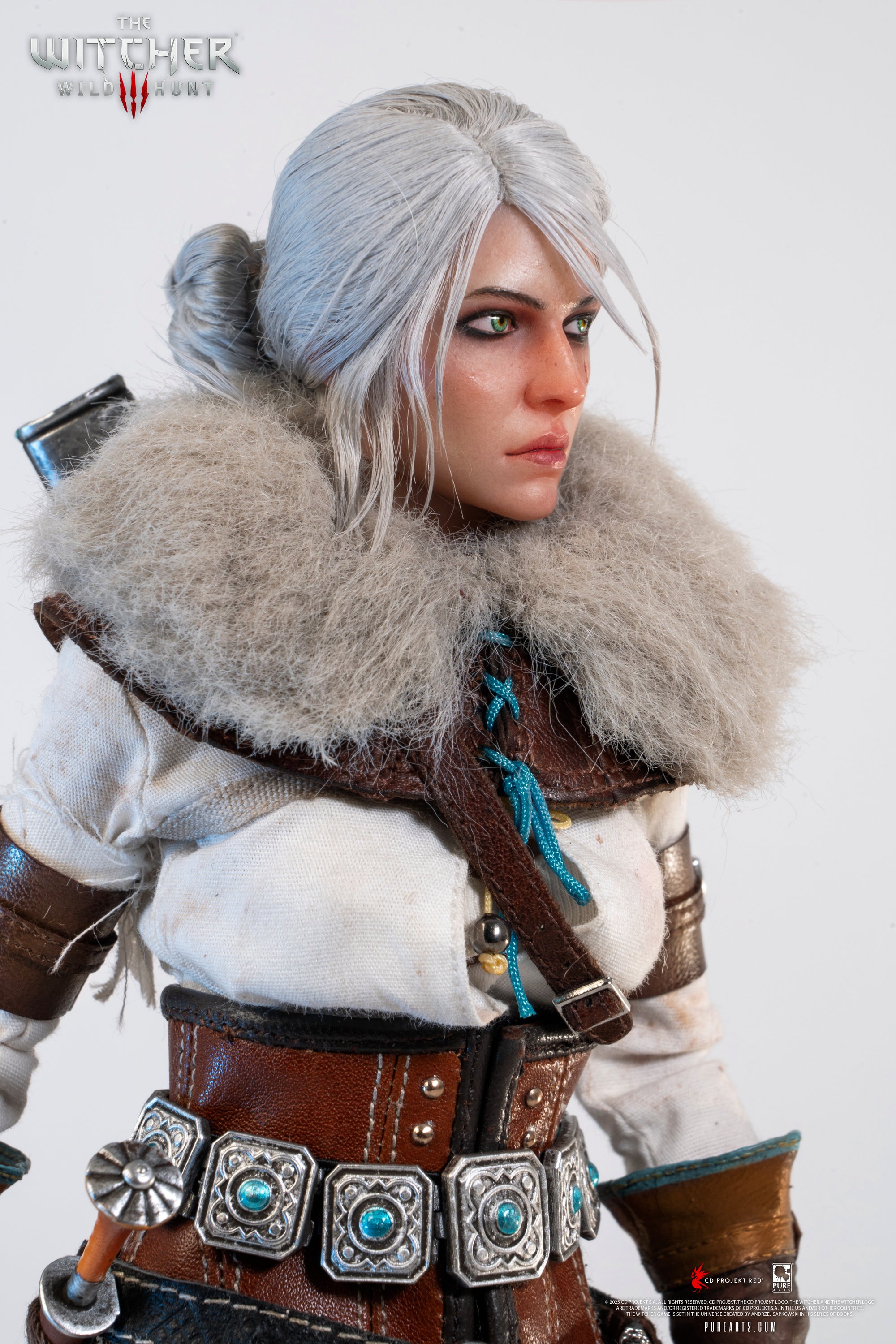 Side portrait of the Ciri figure, showing the fur mantle and the detailing of the leather harness straps.