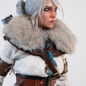 Side portrait of the Ciri figure, showing the fur mantle and the detailing of the leather harness straps.