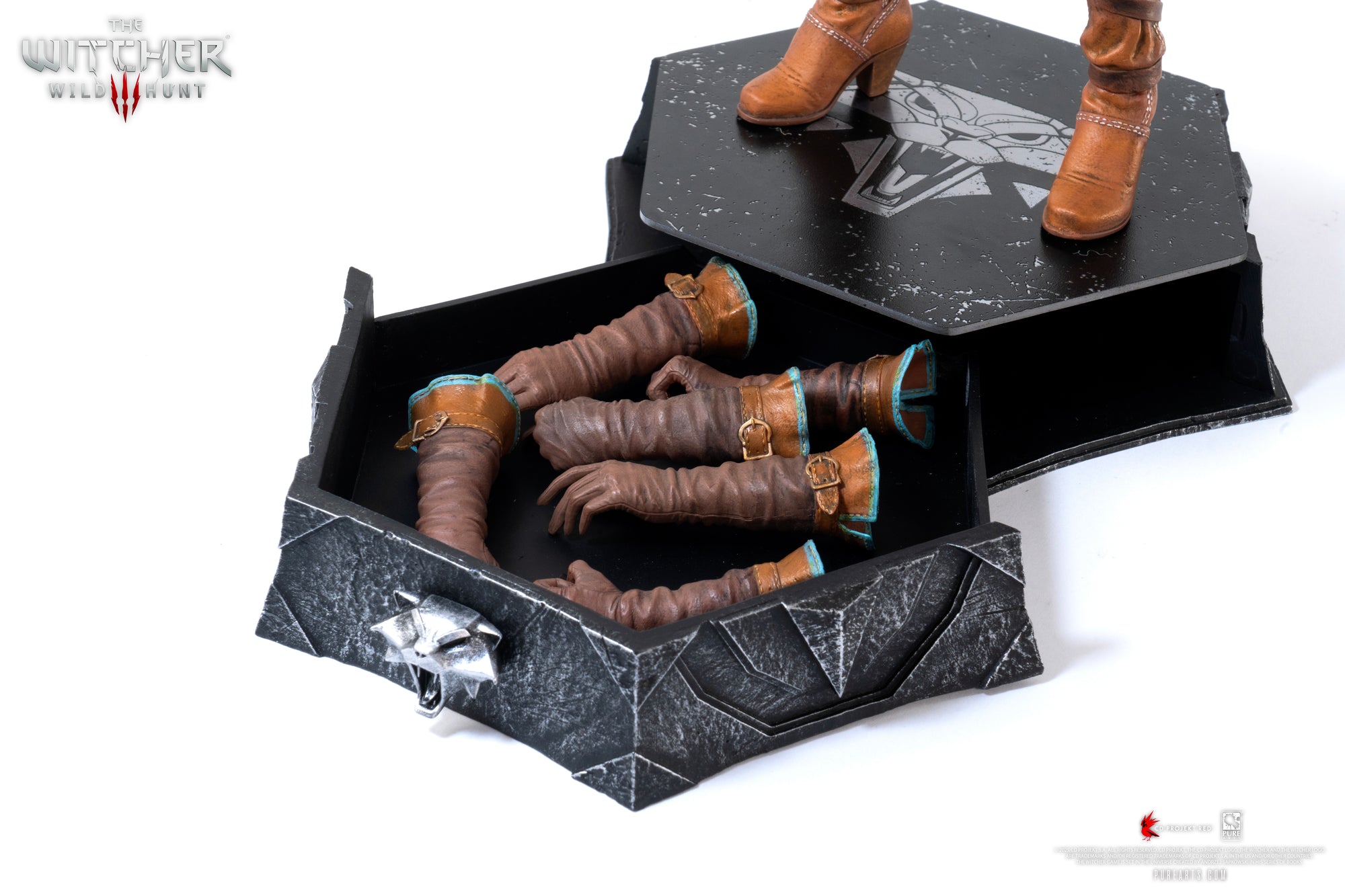 Close-up of the figure's base, showing the lift-off lid revealing storage space for the interchangeable hand sets.