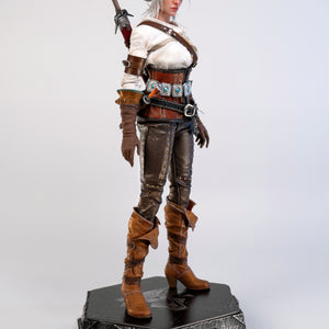 A slightly angled frontal view of the Ciri figure, showing her complete costume and hair bun.