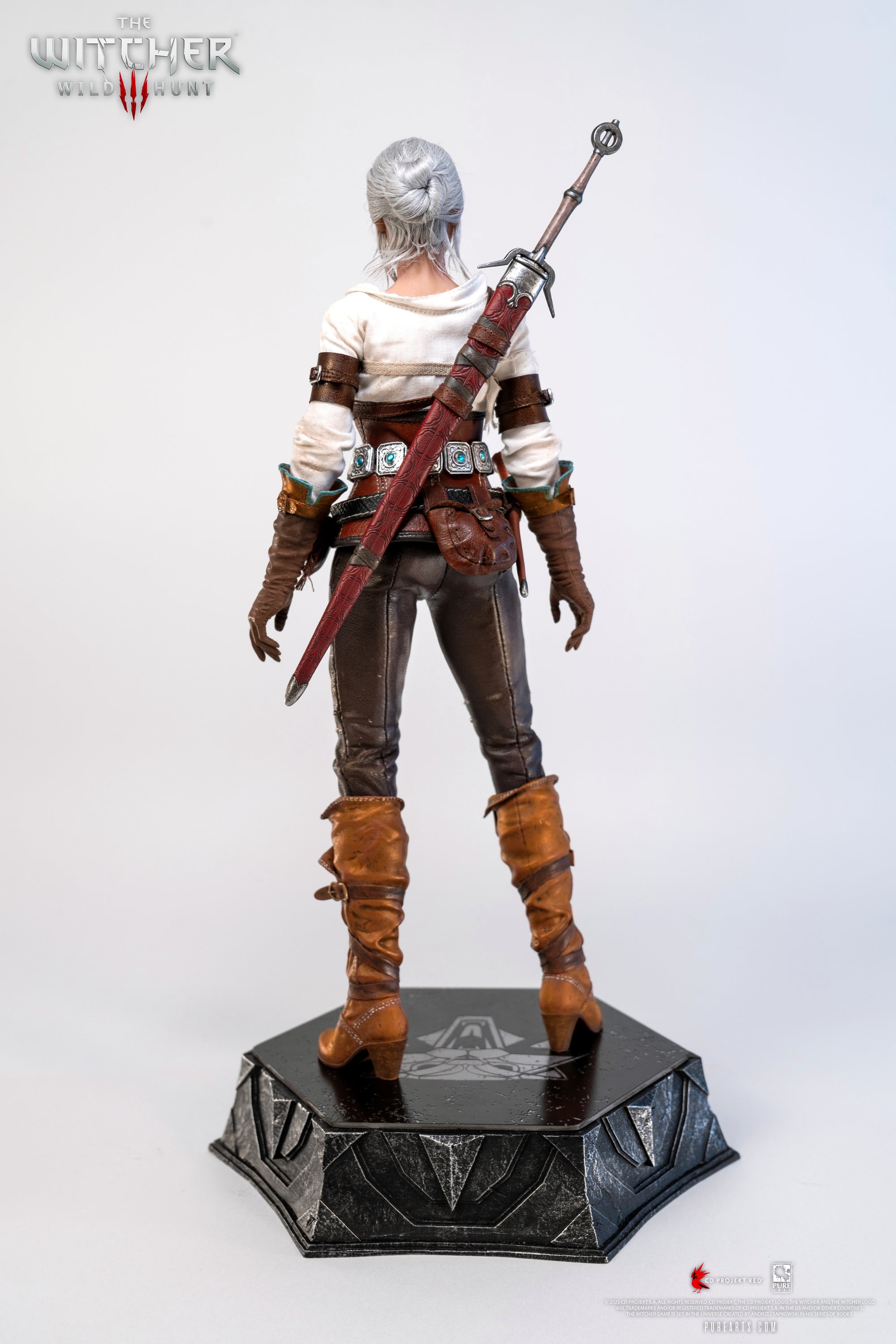 Full rear view of the Ciri figure, focusing on the detail of the sword sheath and her signature brown leather boots.