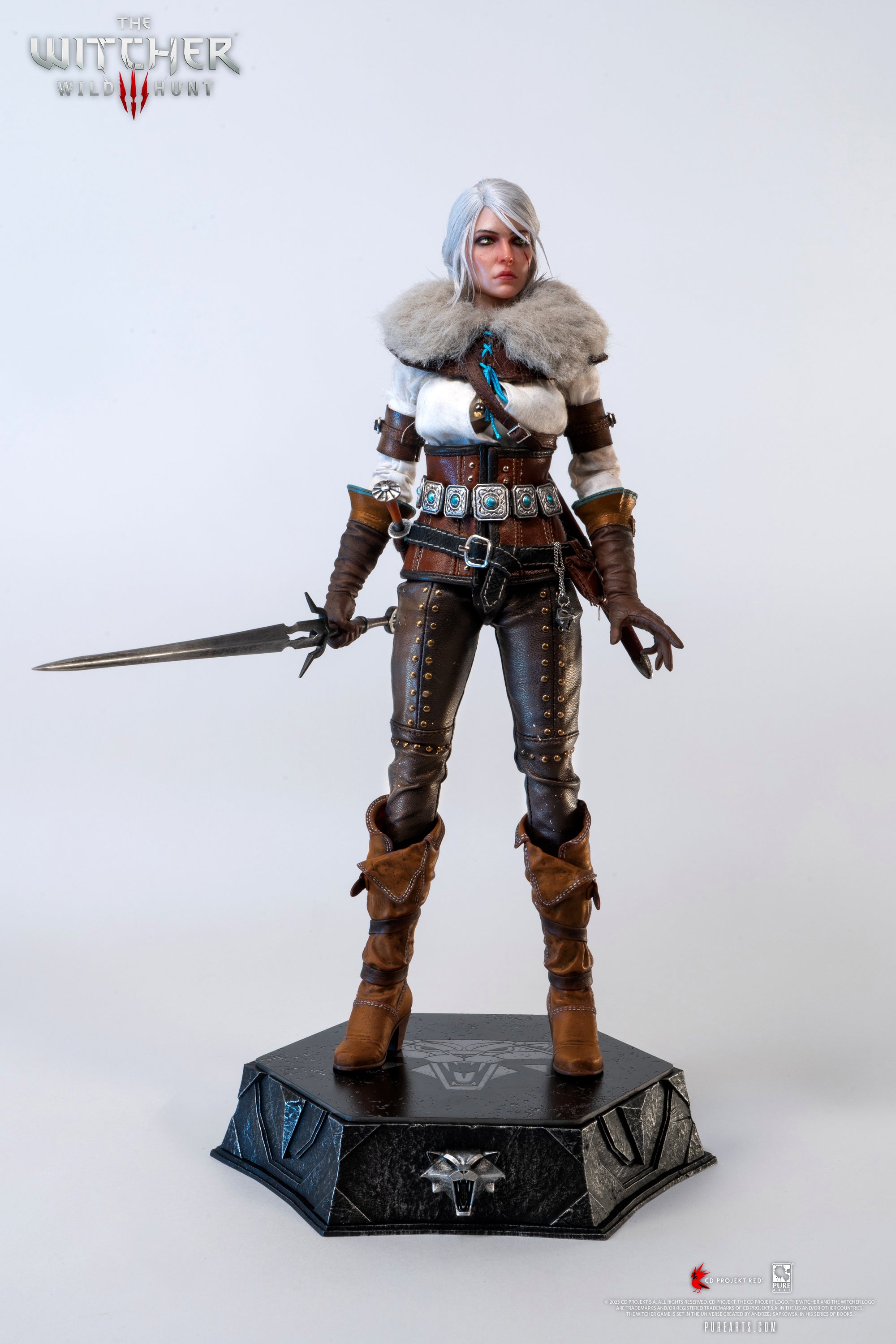 Ciri figure posed with the faux fur mantle accessory and the metal Zireael sword drawn and held low.