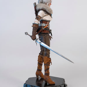Side profile of the Ciri figure holding the metal long sword extended down by her side.